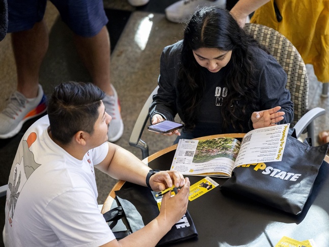 Family members look through App State brochure